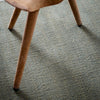 A close up of THE RUNE RUG by FABULA LIVING on a green Gestalt Haus.