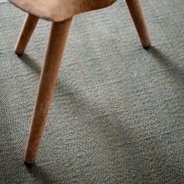 A close up of THE RUNE RUG by FABULA LIVING on a green Gestalt Haus.