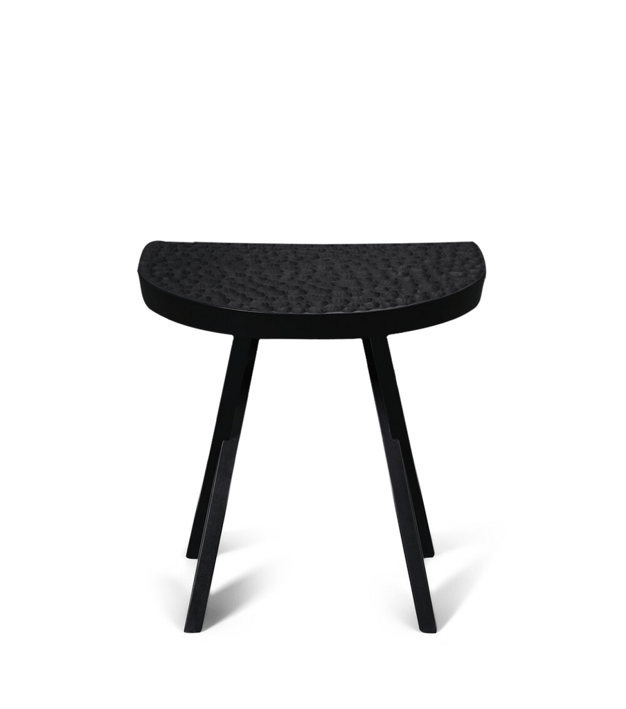 A black Gestalt Haus stools by ZANAT on a white background.