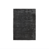 A black Gestalt Haus rug on a white background by FABULA LIVING.