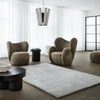 A living room with several chairs and THE VIDAR RUG by FABULA LIVING, featuring a Gestalt Haus design.