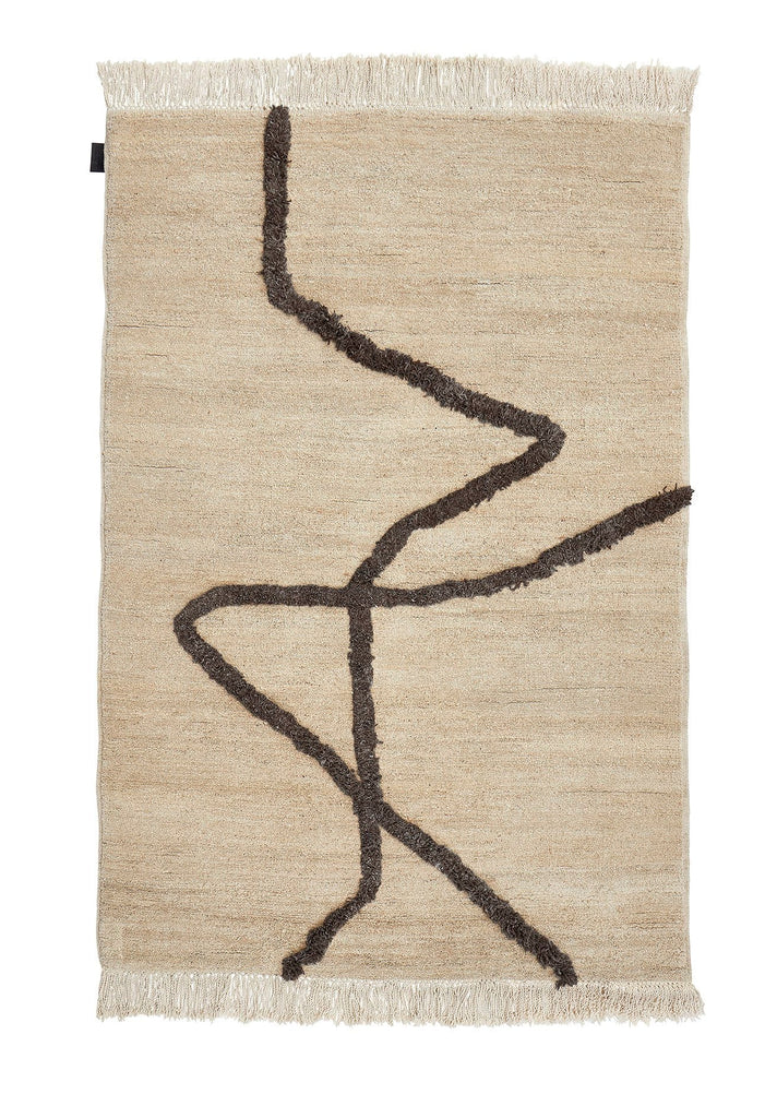 A Gestalt Haus Vuoristo rug with a black and brown design.