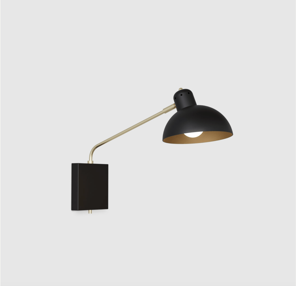 A black and gold wall lamp by LAMBERT ET FILS on a white background.