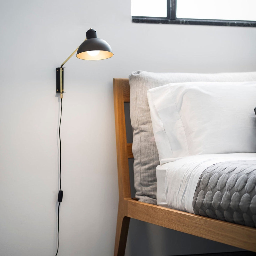 A bed with the Waldorf Wall Lamp by Lambert et Fils next to it in a Gestalt Haus.