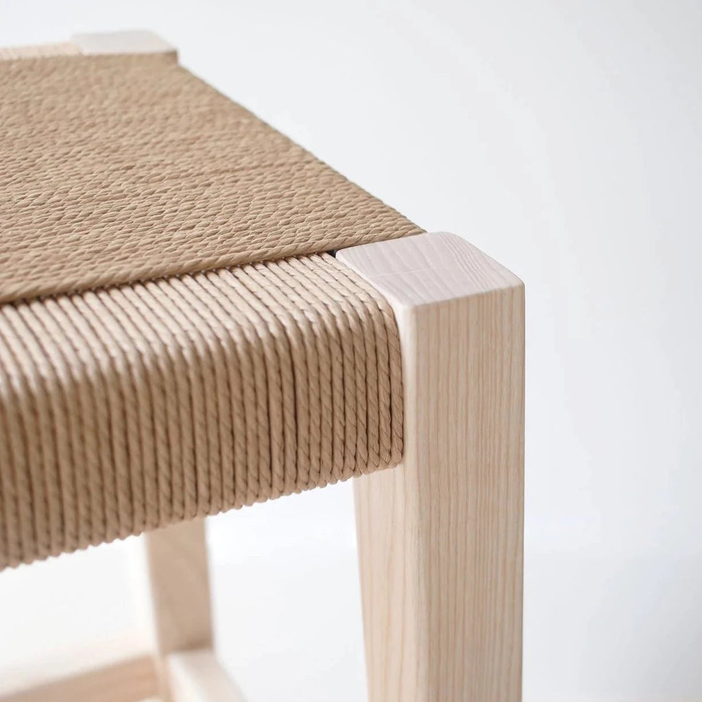 An Origin Made wooden stool with a Weaver's Seat from Gestalt Haus.