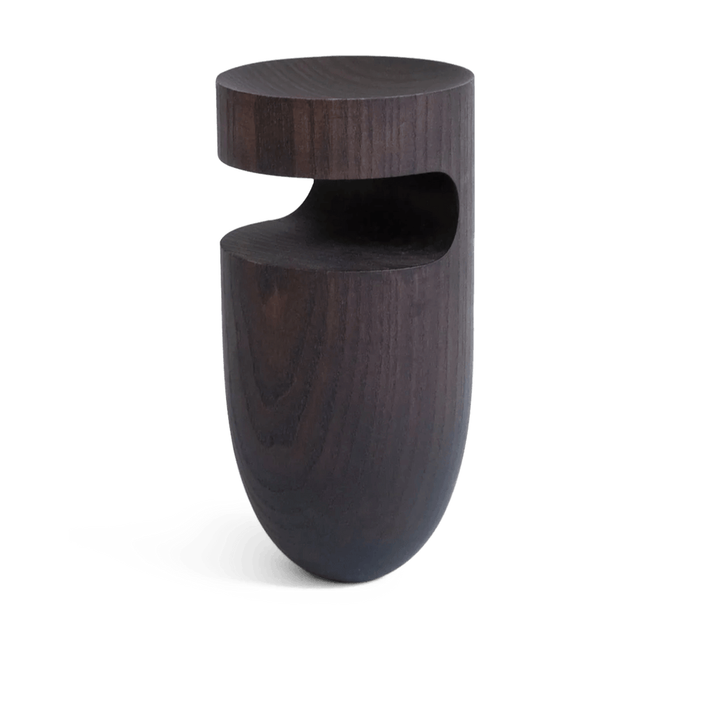 An ORIGIN MADE wooden side table with a circular shape from VOID SCULPTURES, inspired by Gestalt Haus.