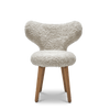 A Gestalt Haus WNG CHAIR with a white fur seat and wooden legs from MAZO.